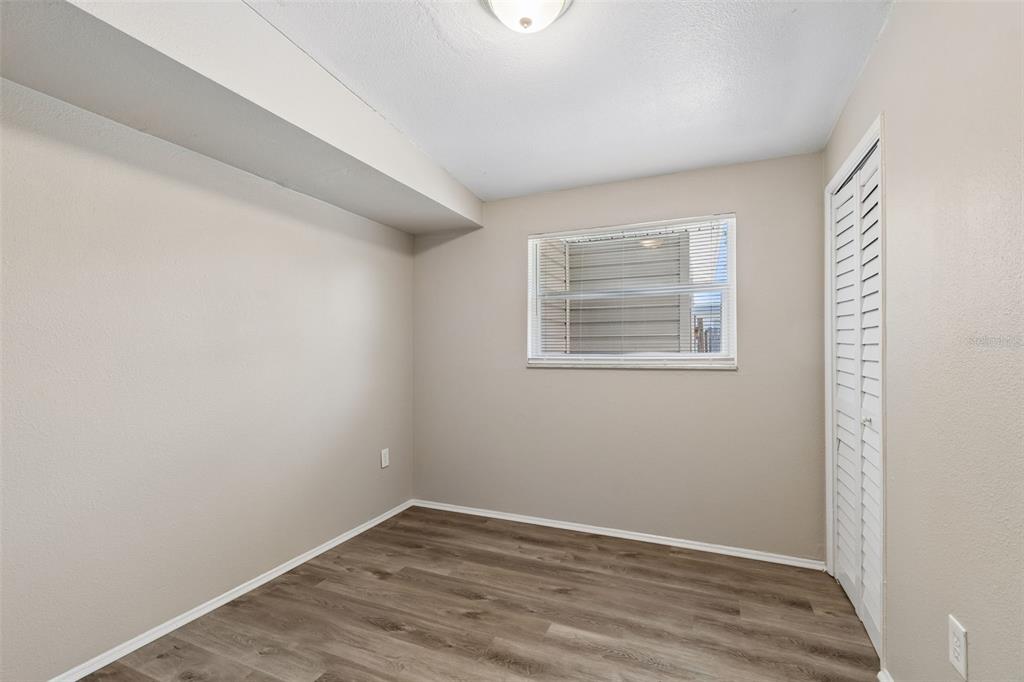 9228 82nd Way Seminole, FL 33777 - Photo 16 of 35 a view of an empty room with wooden floor and a window