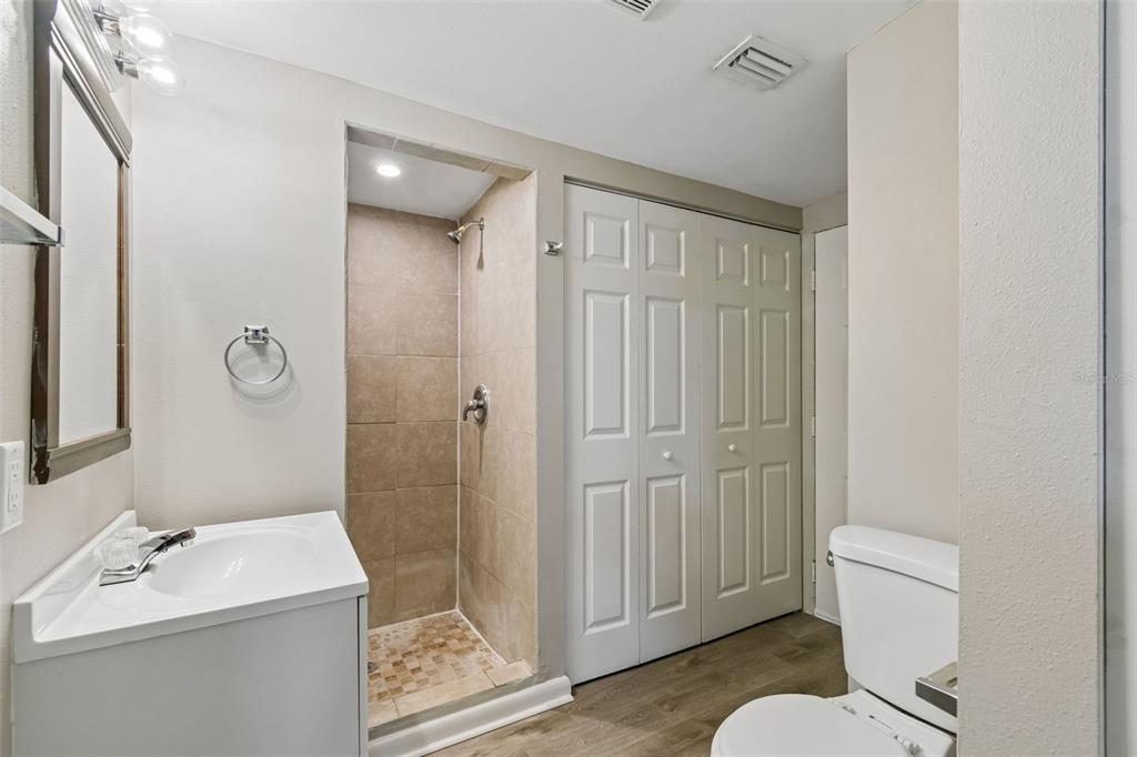 9228 82nd Way Seminole, FL 33777 - Photo 18 of 35 a bathroom with a sink a toilet and shower