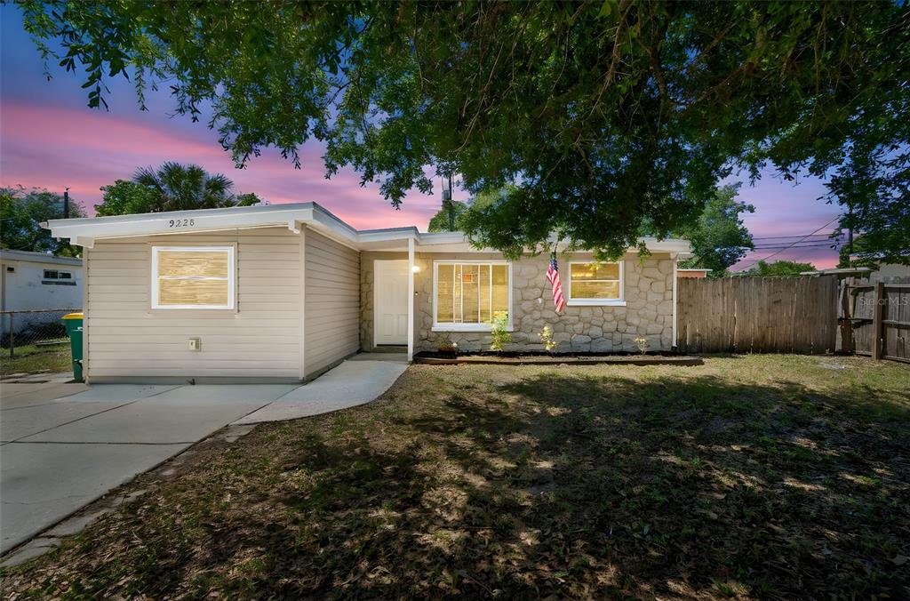 9228 82nd Way Seminole, FL 33777 - Photo 2 of 35 a front view of a house with a yard and garage