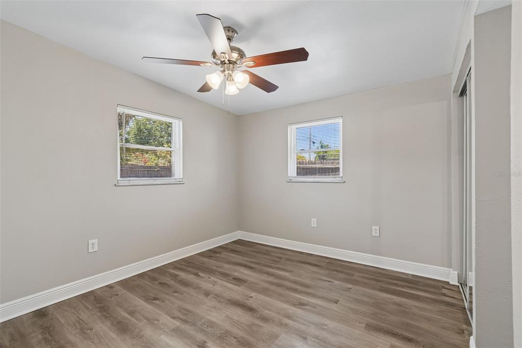 9228 82nd Way Seminole, FL 33777 - Photo 21 of 35 a view of an empty room with wooden floor and a window