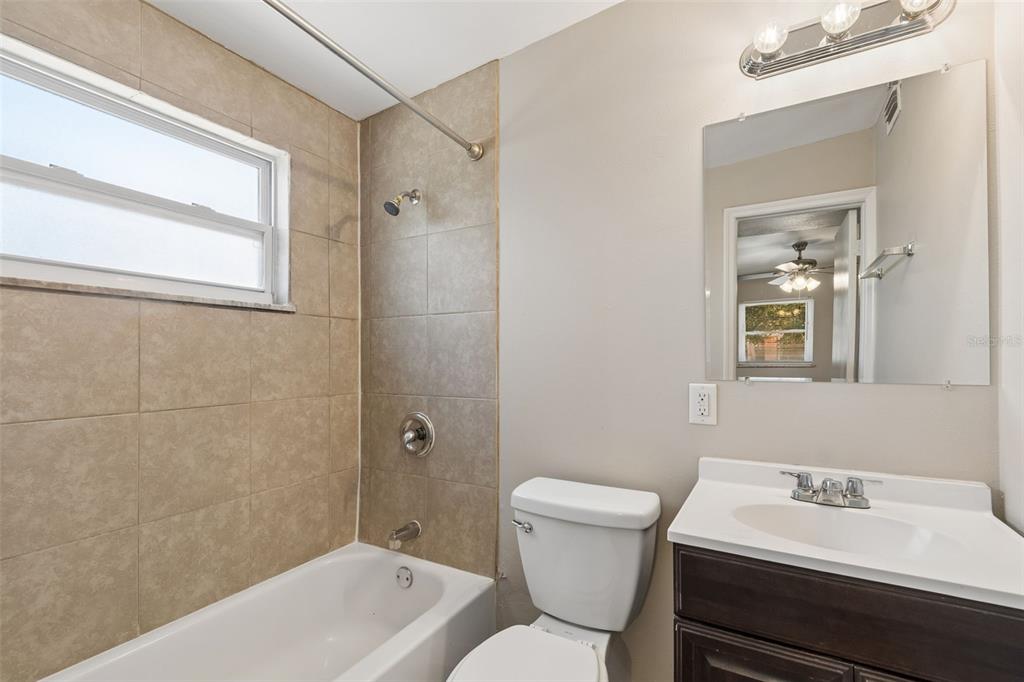 9228 82nd Way Seminole, FL 33777 - Photo 24 of 35 a bathroom with a sink toilet and shower