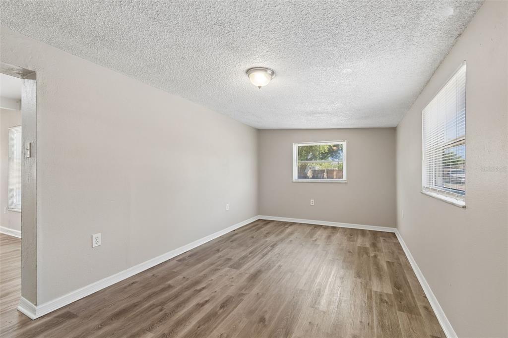 9228 82nd Way Seminole, FL 33777 - Photo 25 of 35 wooden floor in an empty room with a window