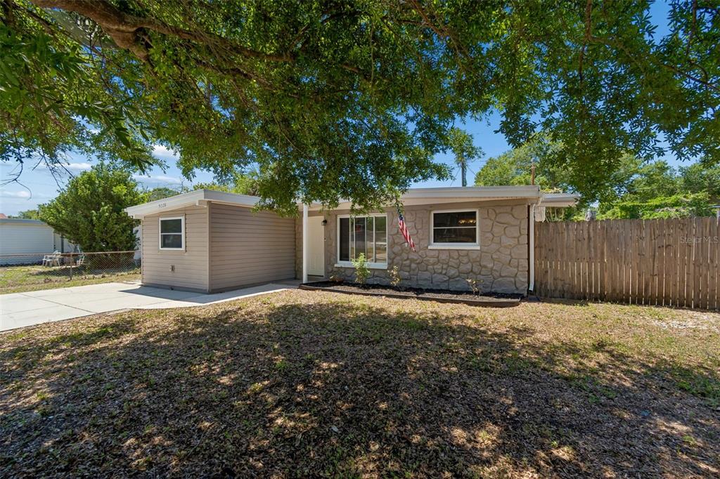 9228 82nd Way Seminole, FL 33777 - Photo 3 of 35 a backyard of a house with yard and tree