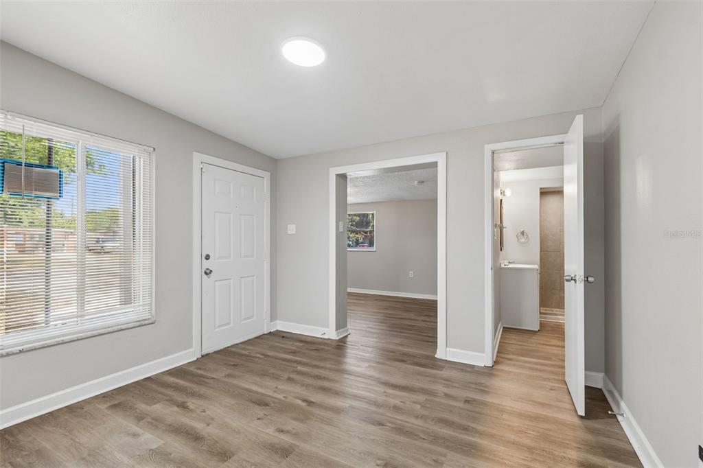 9228 82nd Way Seminole, FL 33777 - Photo 6 of 35 a view of an empty room with wooden floor and window