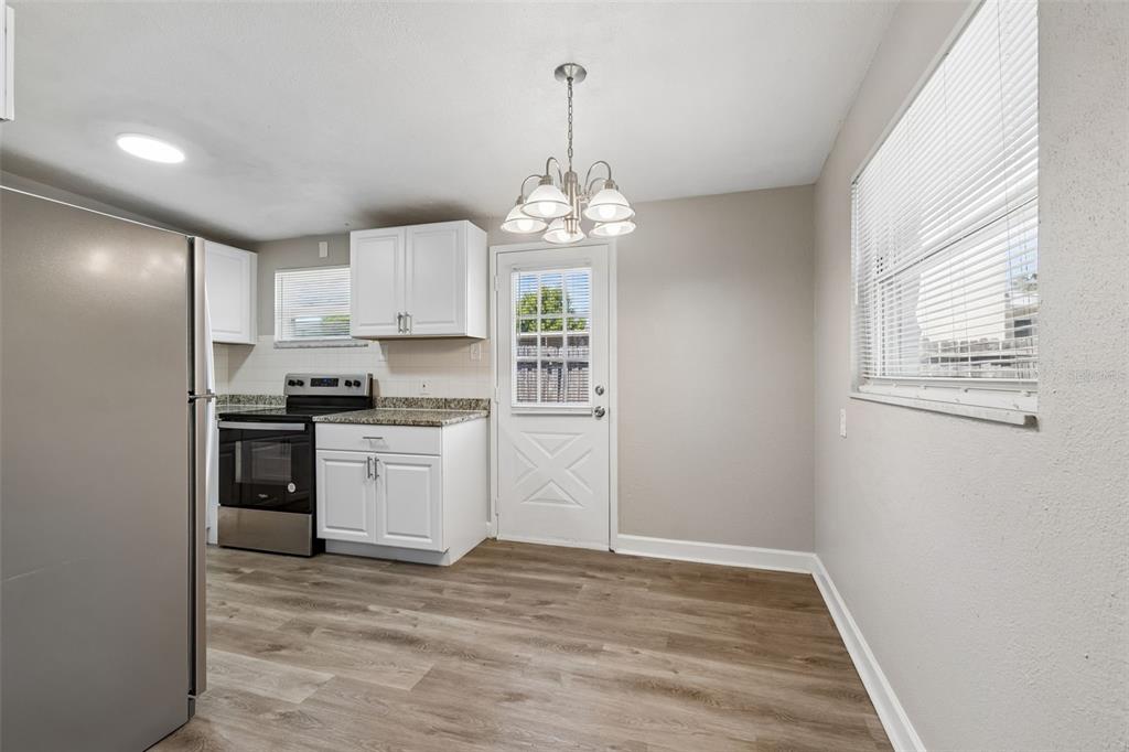9228 82nd Way Seminole, FL 33777 - Photo 9 of 35 a kitchen with stainless steel appliances granite countertop a refrigerator and a stove top oven