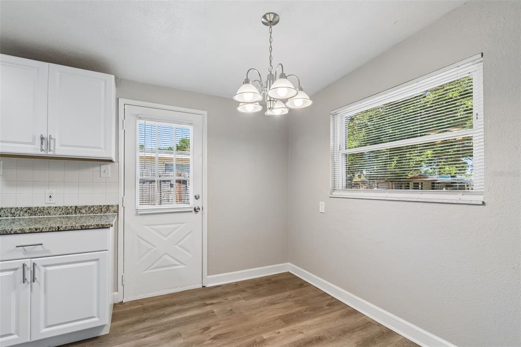 9228 82nd Way Seminole, FL 33777 - Photo 10 of 35 a view of a kitchen with wooden floor and a window