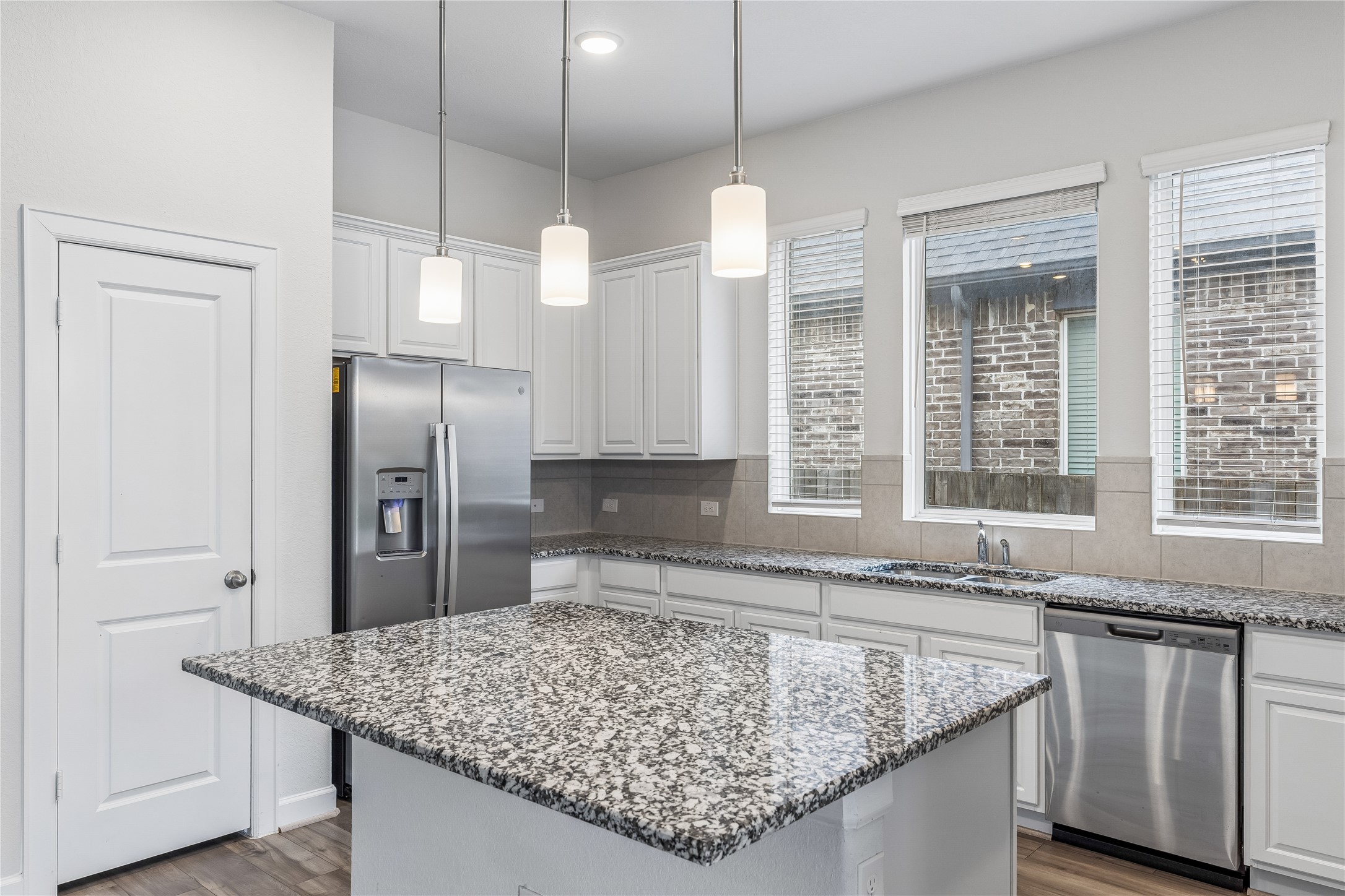 298 Wild Pecan Loop Buda, TX 78610 - Photo 12 of 40 a kitchen with stainless steel appliances granite countertop a sink stove and refrigerator