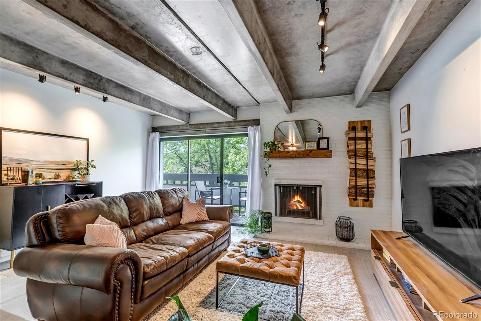 555 East 10th Avenue, Unit 303 Denver, CO 80203 - Photo 1 of 23 a living room with furniture and a fireplace