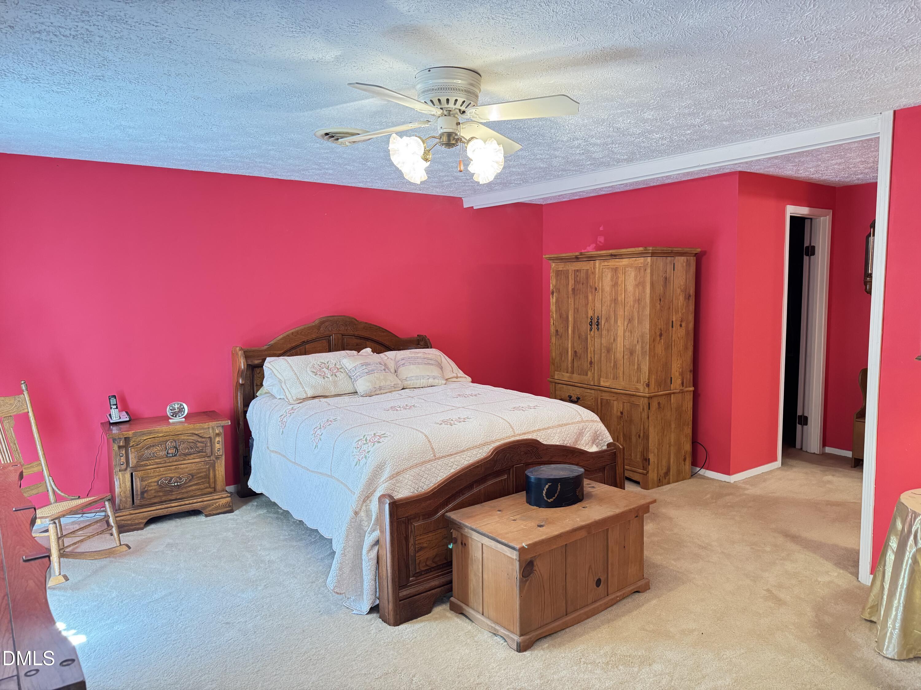 84 Wintergreen Road Henderson, NC 27537 - Photo 21 of 49 a bed room with a bed and a chandelier