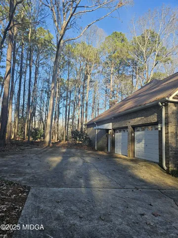 a front view of a house with a yard and trees