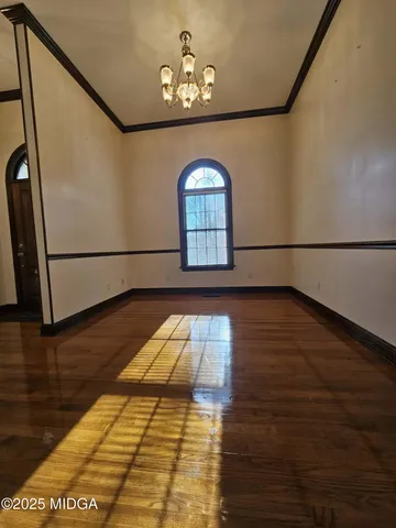 a kitchen with sink a refrigerator and wooden cabinets