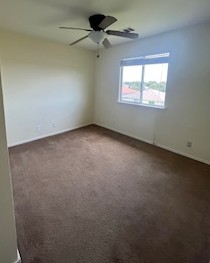 14909 Nuttall Drive Austin, TX 78724 - Photo 12 of 13 Empty room featuring dark colored carpet and ceiling fan