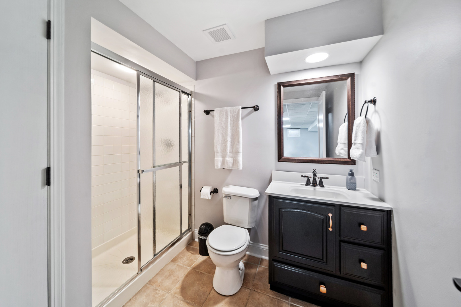 28W140 Mack Road Wheaton, IL 60189 - Photo 34 of 48 a bathroom with a toilet a sink a tub and mirror