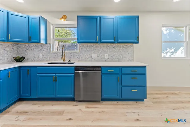 a kitchen with stainless steel appliances granite countertop wooden cabinets a sink and a window