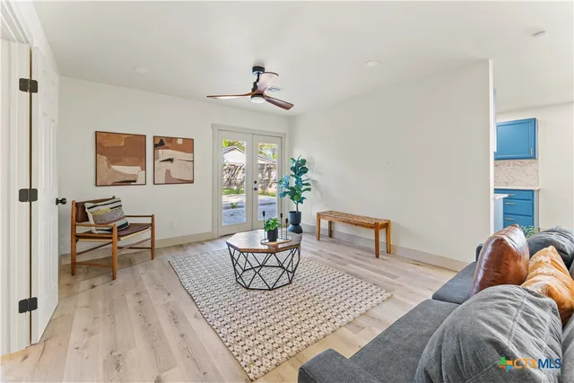 a living room with furniture and a wooden floor