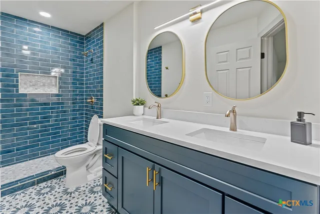 a bathroom with a sink a toilet and shower