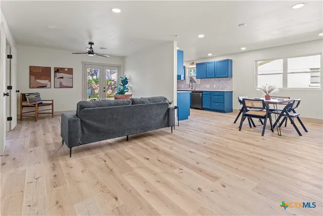 a living room with furniture and a wooden floor