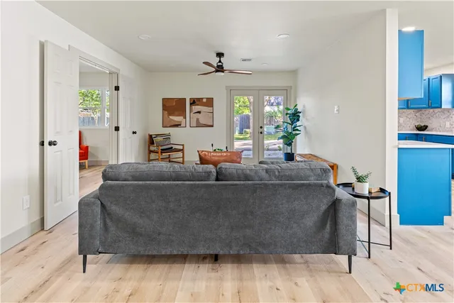 a living room with furniture and a chandelier