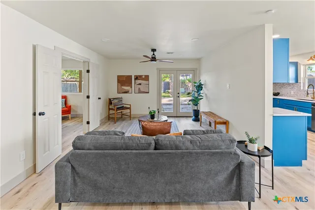 a living room with furniture and a chandelier