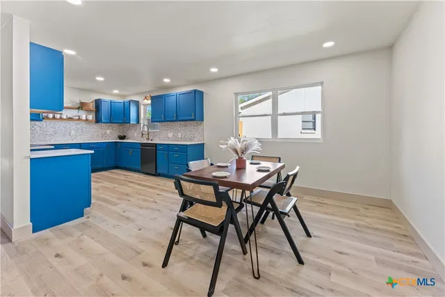 a kitchen with a table and chairs in it