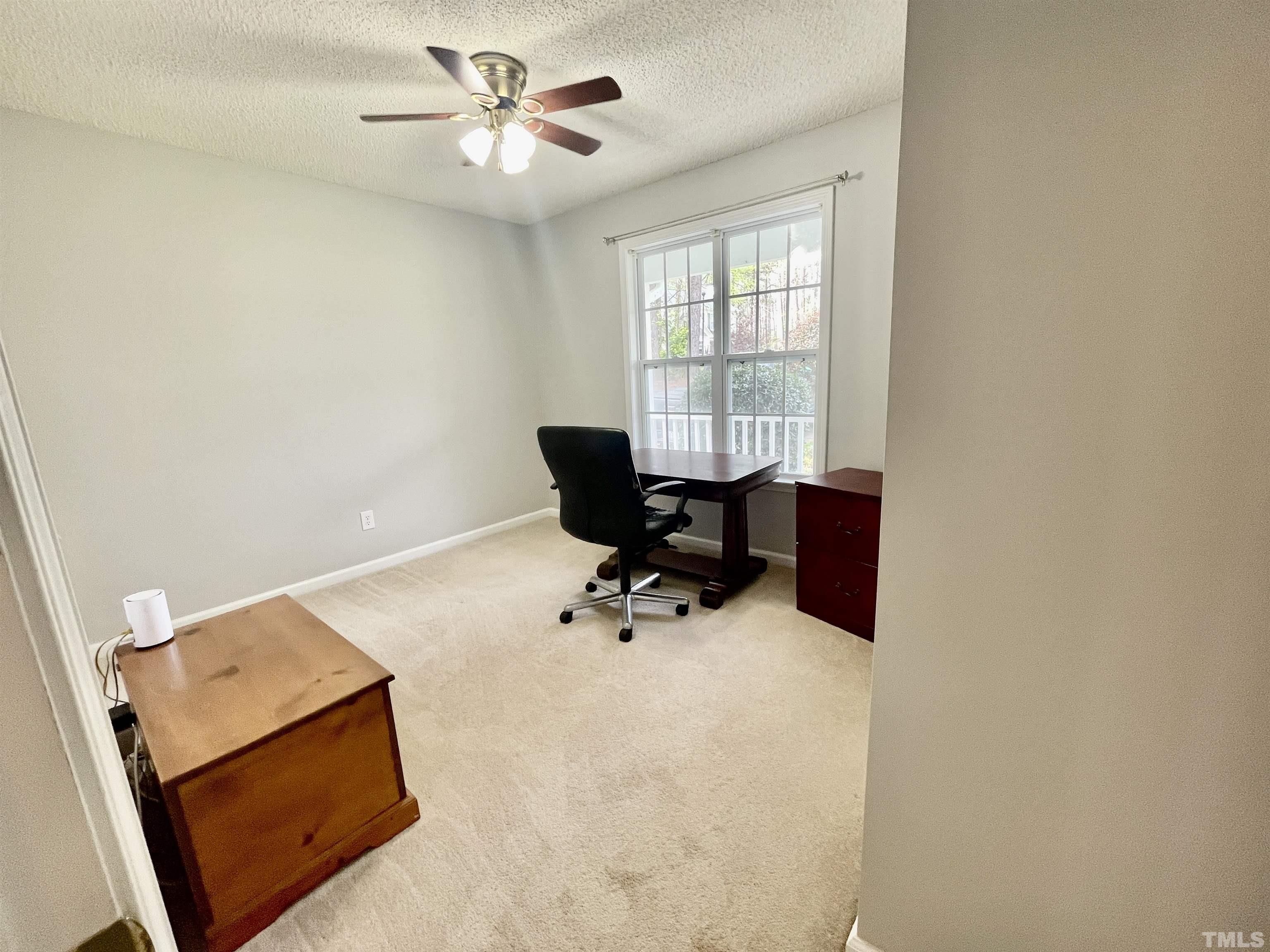 6105 Ruddington Court Willow Spring, NC 27592 - Photo 11 of 18 an workspace with wooden floor and a window