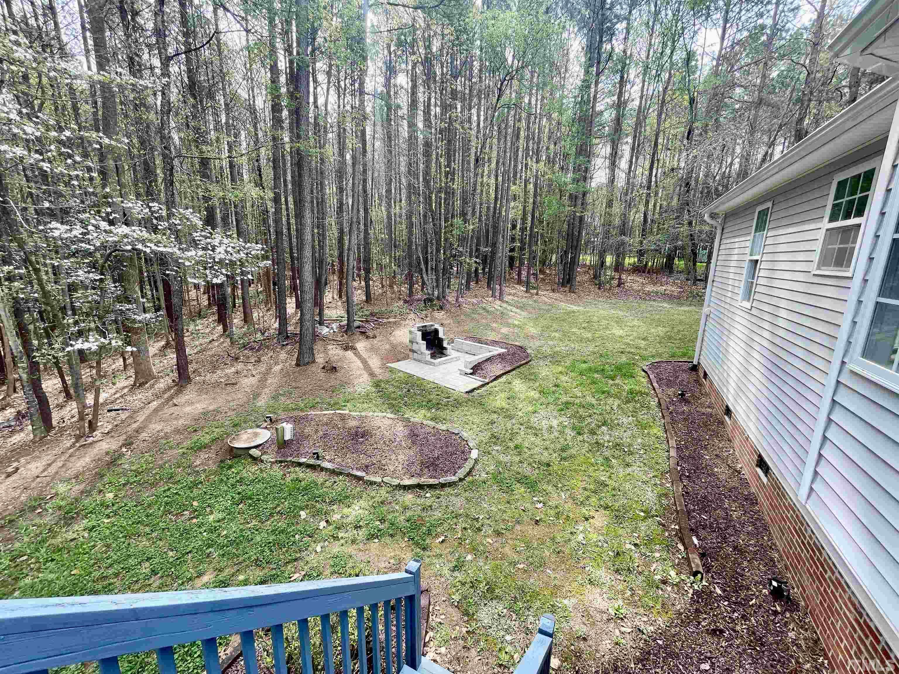 6105 Ruddington Court Willow Spring, NC 27592 - Photo 13 of 18 a backyard of a house with outdoor seating