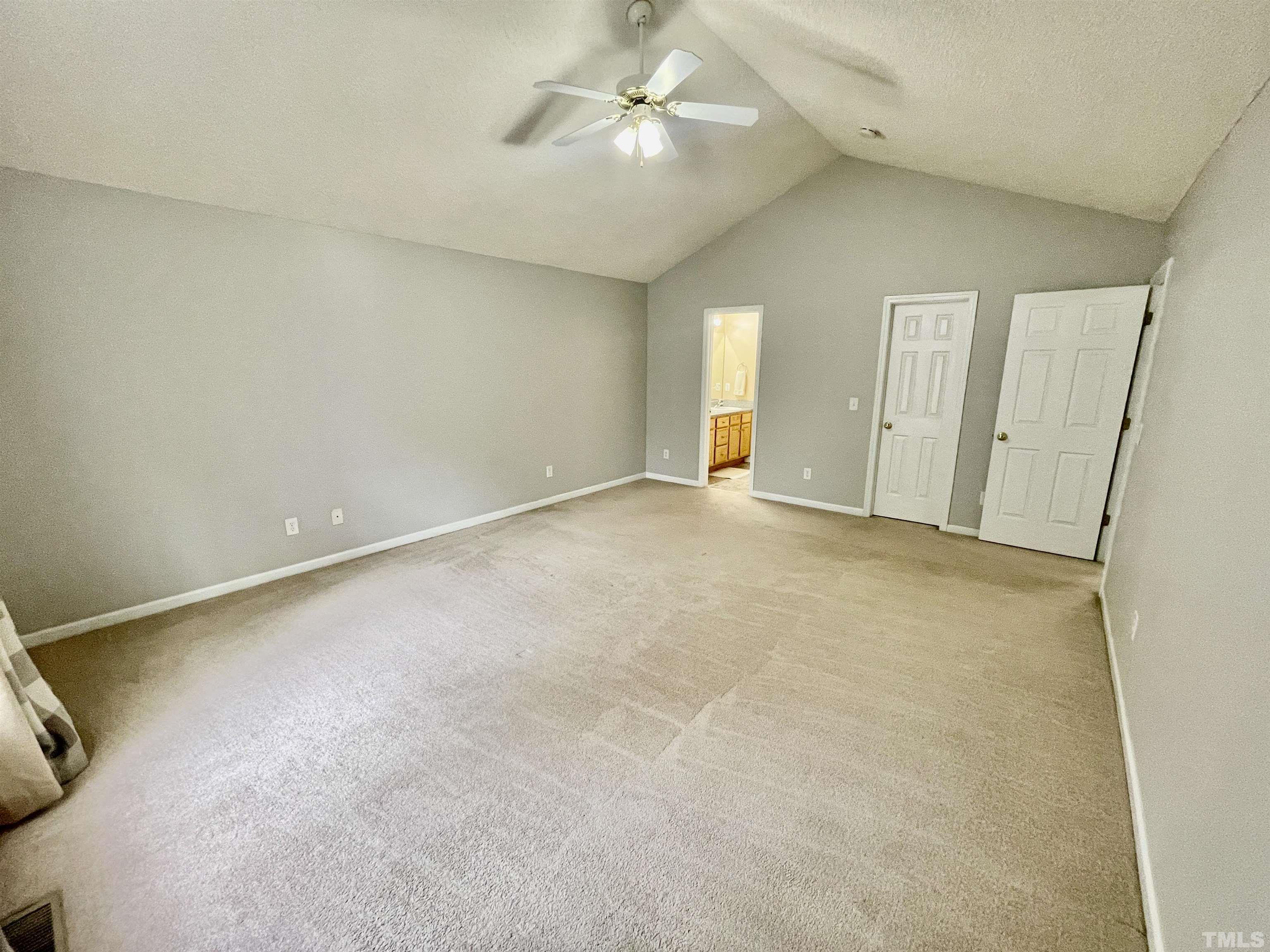 6105 Ruddington Court Willow Spring, NC 27592 - Photo 7 of 18 an empty room with a ceiling fan and a window
