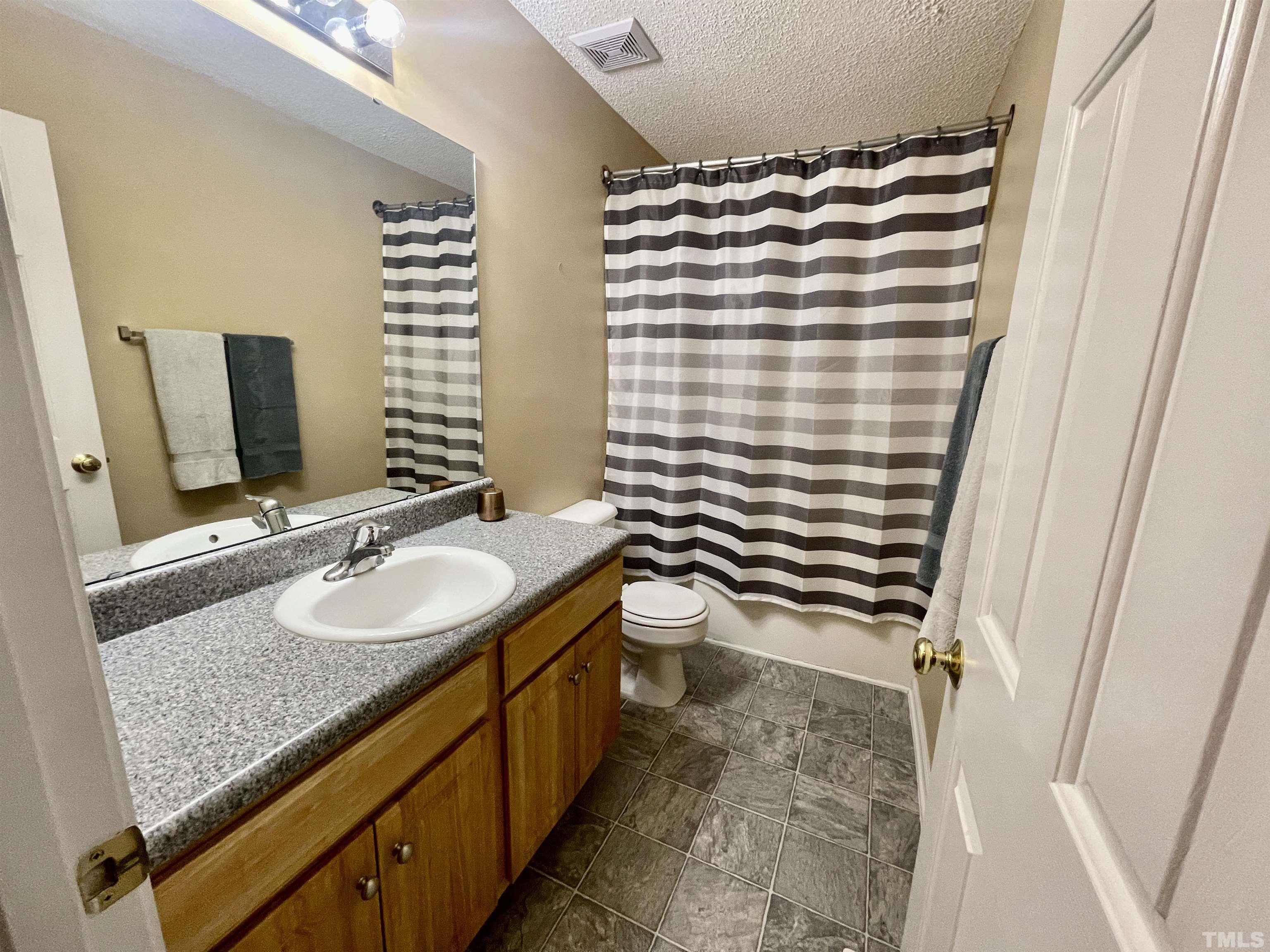 6105 Ruddington Court Willow Spring, NC 27592 - Photo 10 of 18 a bathroom with a sink and a mirror