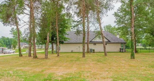 a house that has a tree in front of it