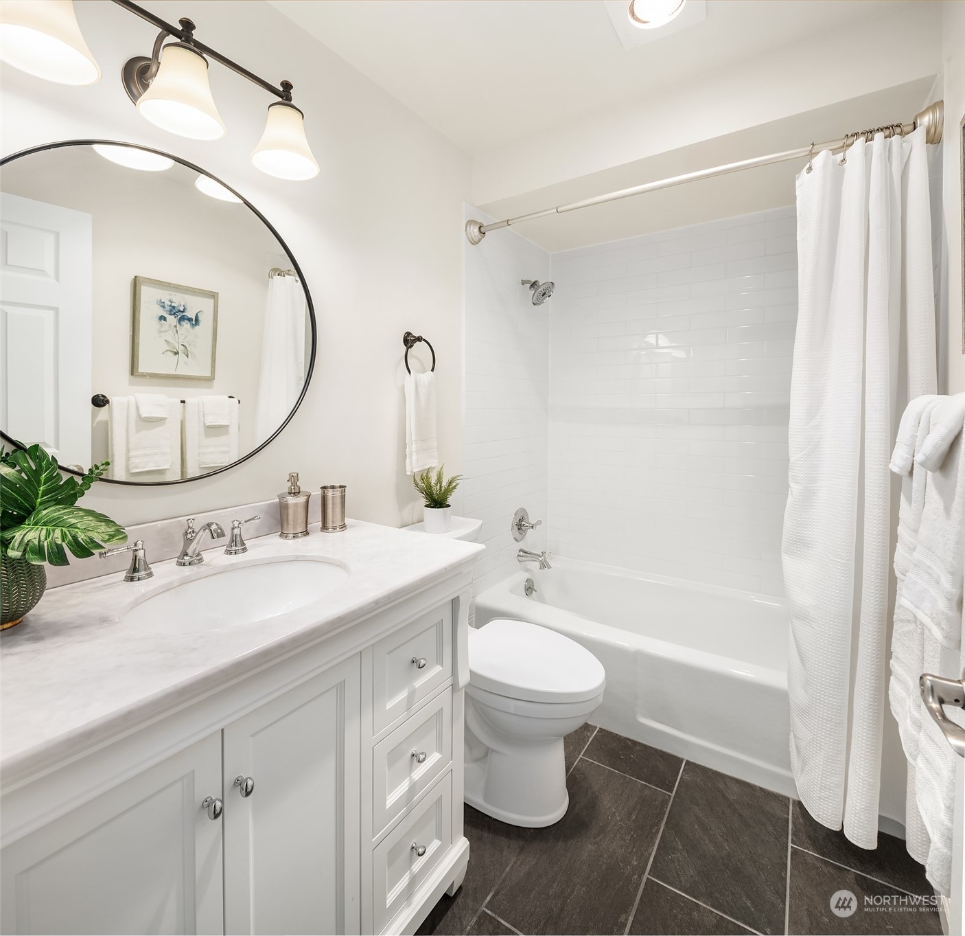 8001 Sand Point Way Northeast, Unit C22 Seattle, WA 98115 - Photo 13 of 27 a bathroom with a sink a toilet and a mirror
