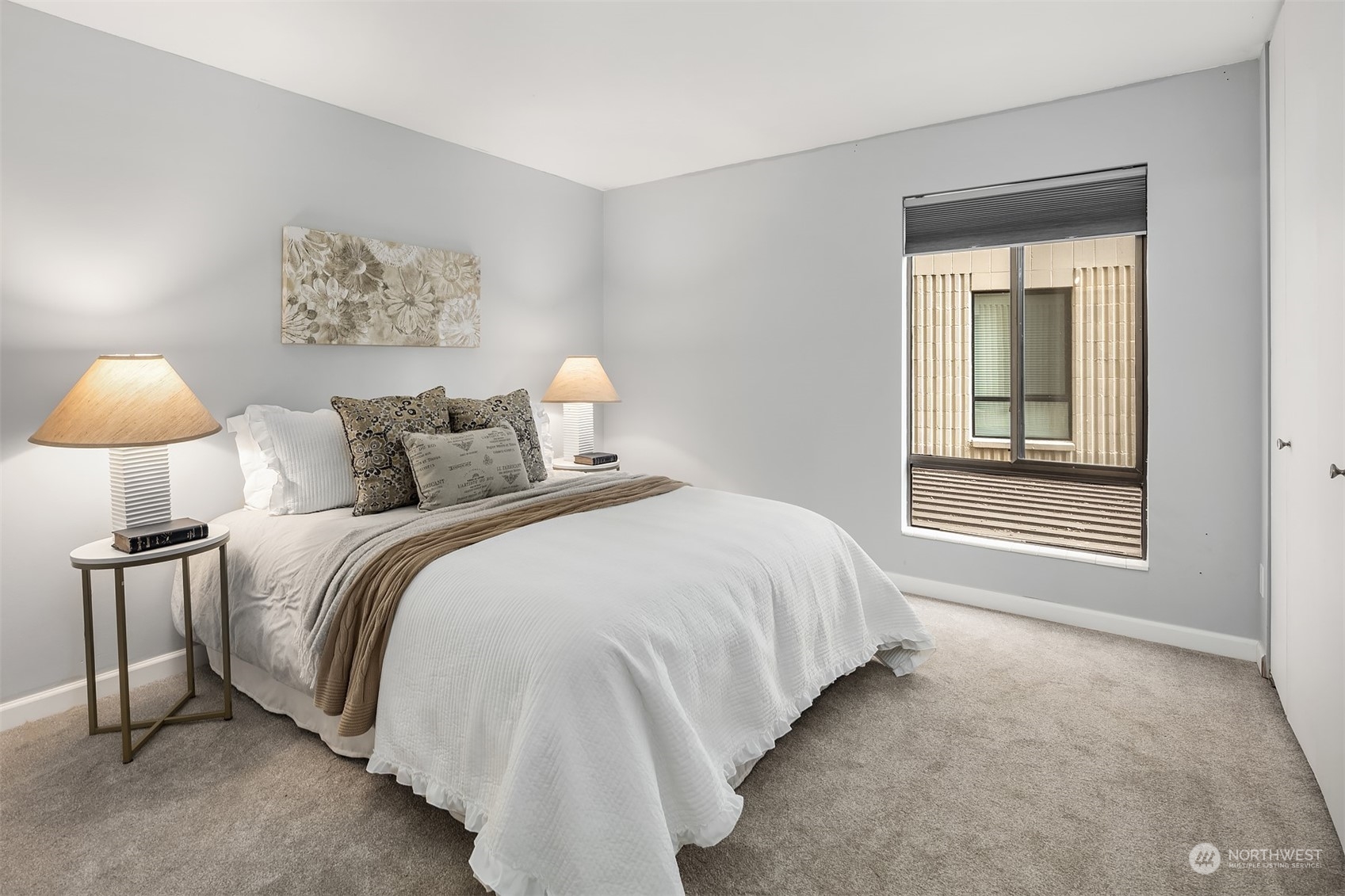 8001 Sand Point Way Northeast, Unit C22 Seattle, WA 98115 - Photo 14 of 27 a bedroom with a bed and lamp