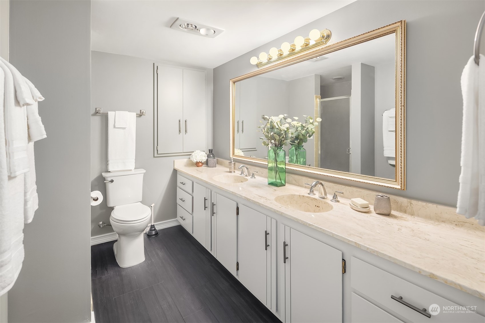 8001 Sand Point Way Northeast, Unit C22 Seattle, WA 98115 - Photo 16 of 27 a bathroom with a double vanity sink toilet and mirror