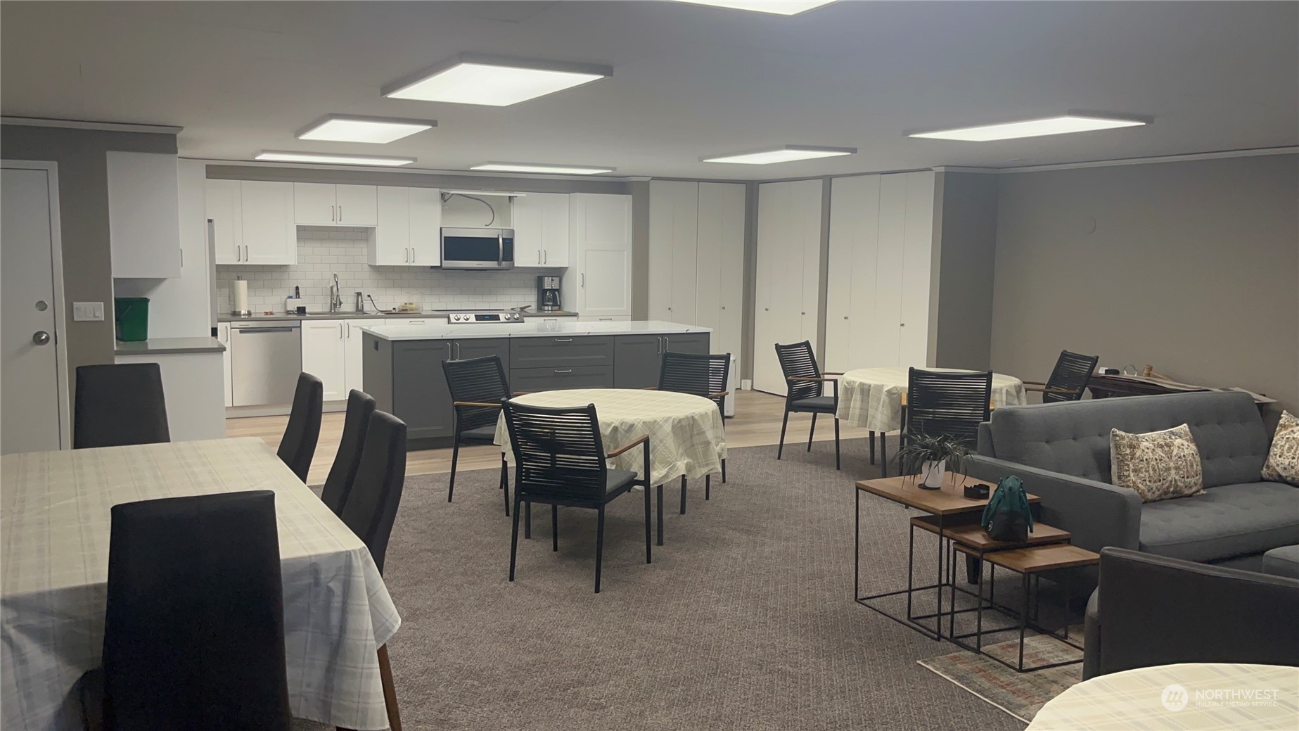 8001 Sand Point Way Northeast, Unit C22 Seattle, WA 98115 - Photo 20 of 27 a living room with furniture a dining table and chairs