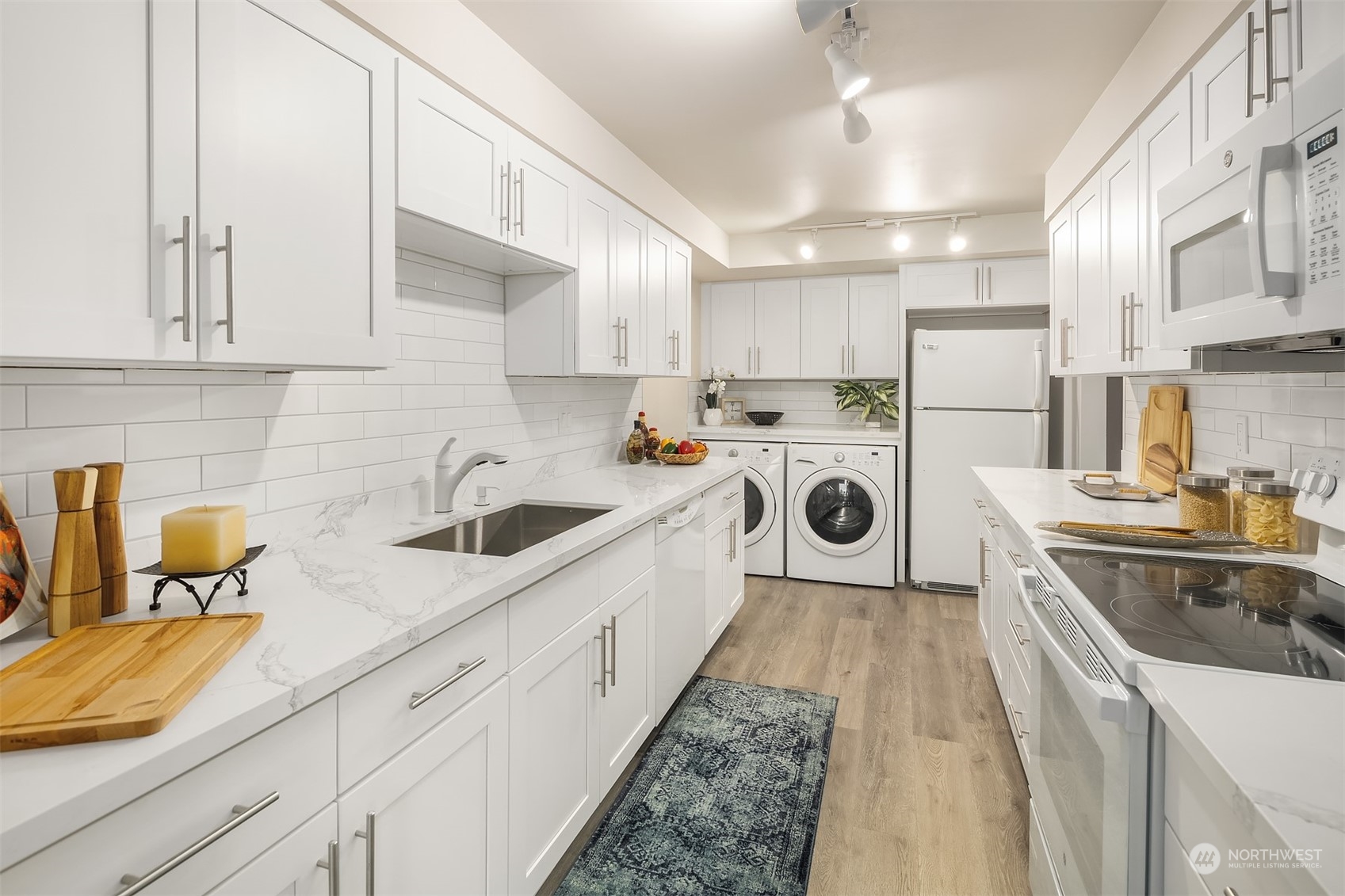 8001 Sand Point Way Northeast, Unit C22 Seattle, WA 98115 - Photo 5 of 27 a kitchen with stainless steel appliances granite countertop a sink a stove and cabinets