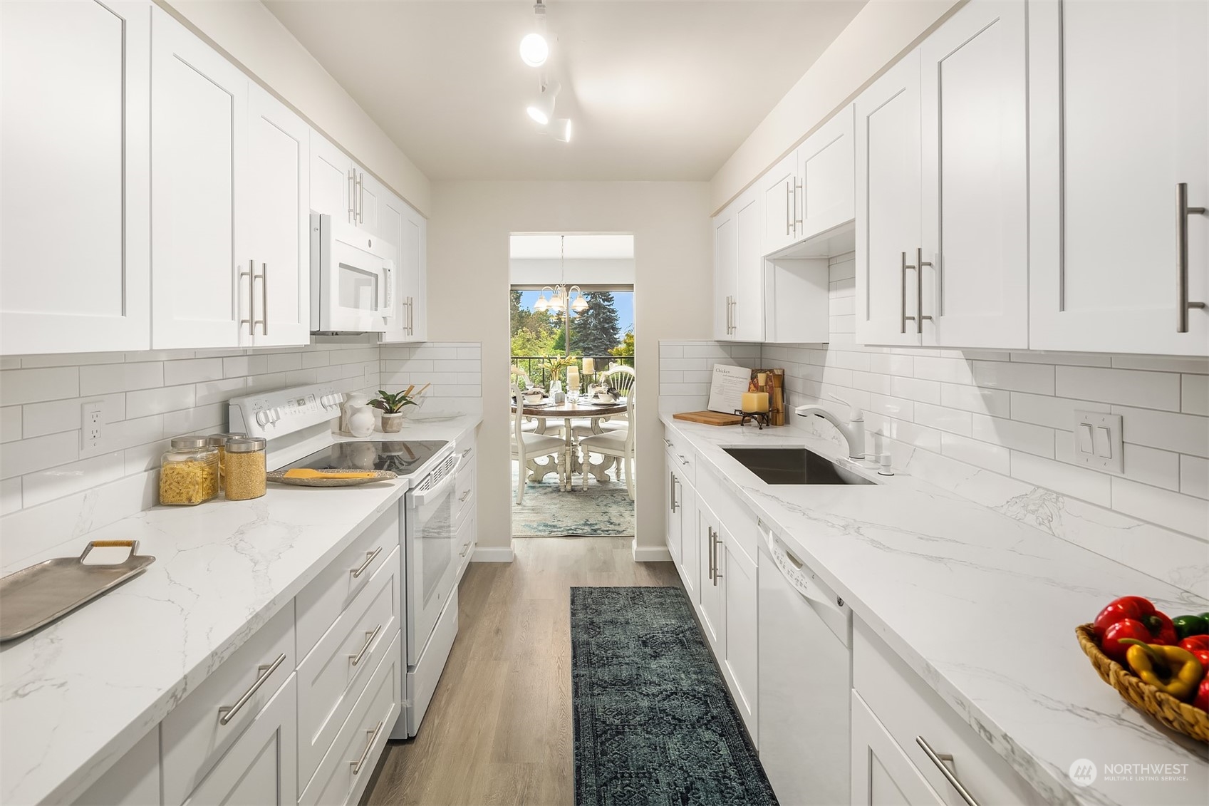 8001 Sand Point Way Northeast, Unit C22 Seattle, WA 98115 - Photo 8 of 27 a kitchen with a sink a stove and cabinets