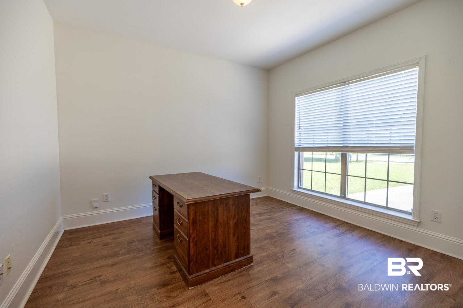 101 Normandy Street Fairhope, AL 36532 - Photo 1 of 18 Unfurnished office featuring baseboards and dark wood finished floors