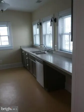 a kitchen with a sink stove and window