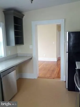 a view of an empty room and a window