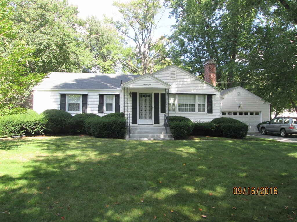 38 Greaney Street Springfield, MA 01104 - Photo 1 of 25 a front view of a house with a garden