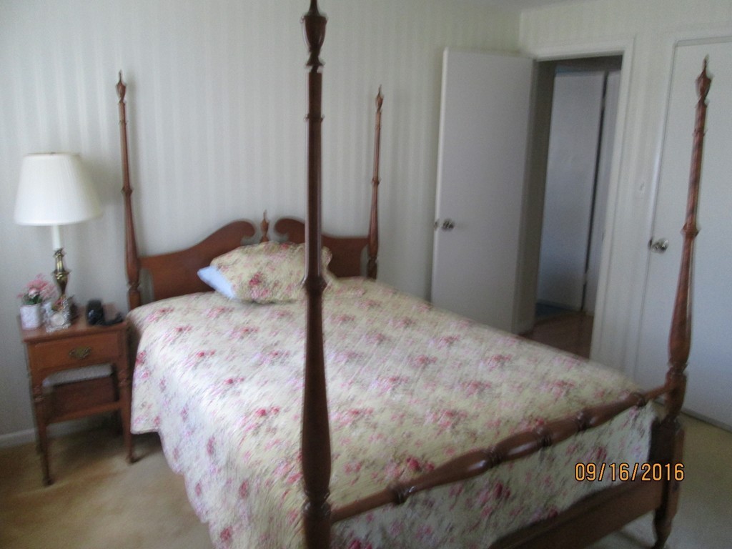38 Greaney Street Springfield, MA 01104 - Photo 14 of 25 a bedroom with a bed and a lamp