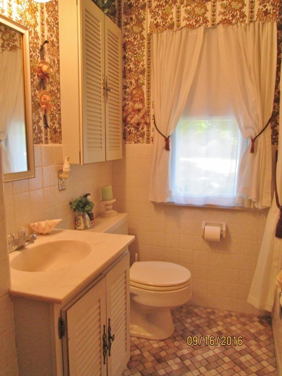 38 Greaney Street Springfield, MA 01104 - Photo 17 of 25 a bathroom with a sink a toilet and a window