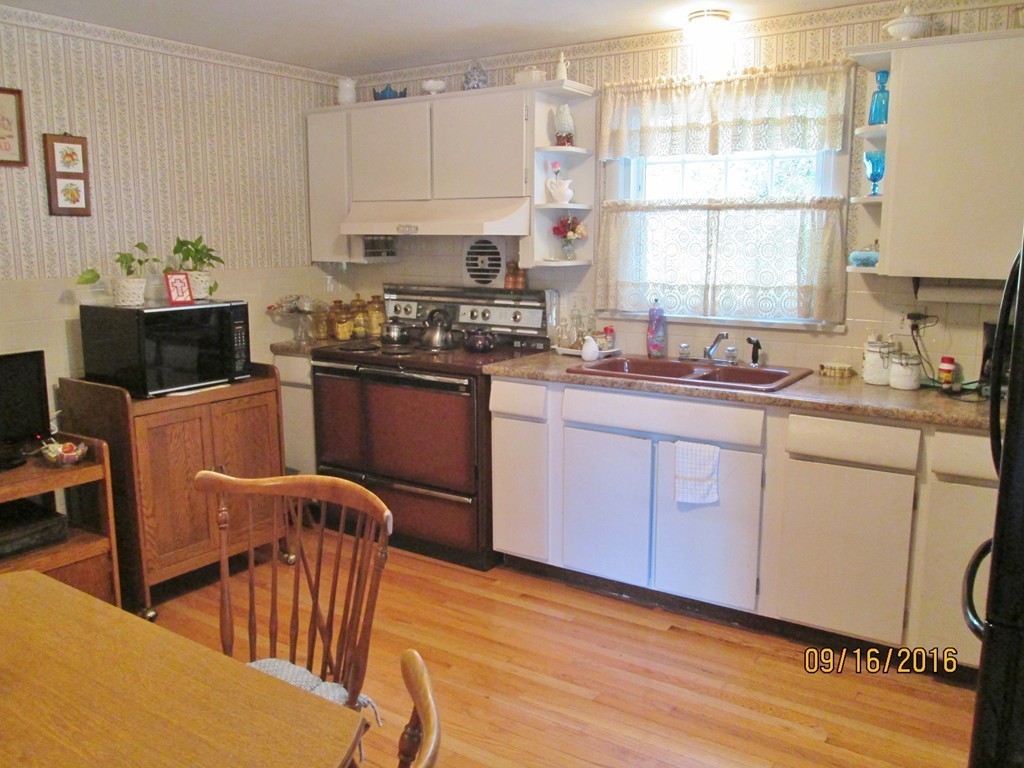 38 Greaney Street Springfield, MA 01104 - Photo 7 of 25 a kitchen with stainless steel appliances granite countertop a sink a stove a dining table and chairs
