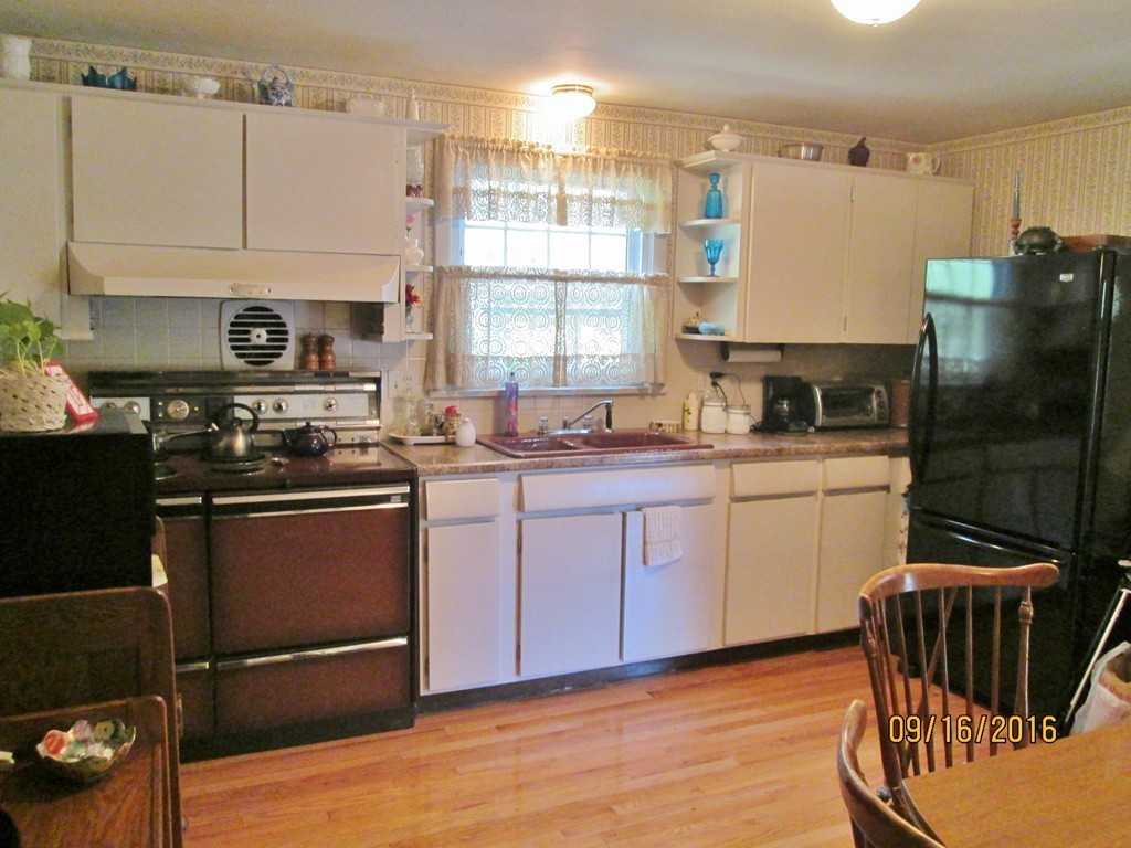 38 Greaney Street Springfield, MA 01104 - Photo 8 of 25 a kitchen with a sink appliances cabinets and a counter top space