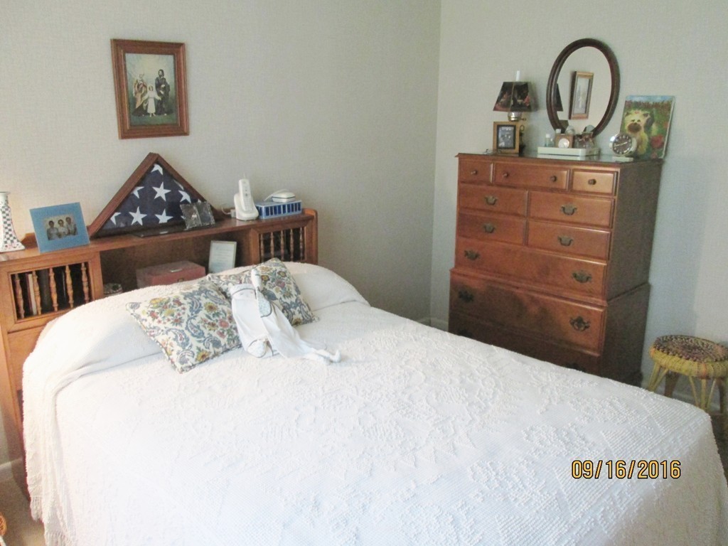 38 Greaney Street Springfield, MA 01104 - Photo 9 of 25 a bedroom with a bed and a dresser