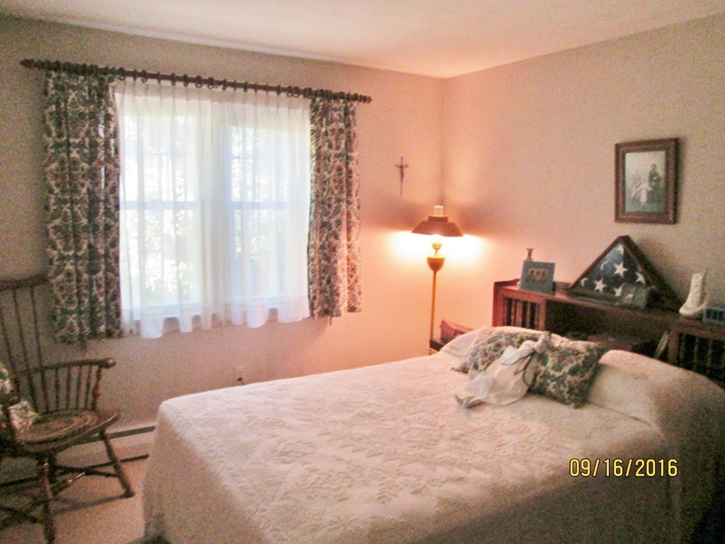 38 Greaney Street Springfield, MA 01104 - Photo 10 of 25 a bedroom with a bed and wooden floor
