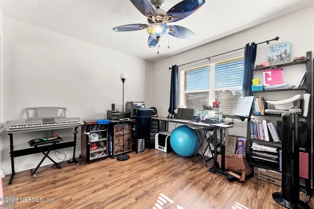a view of a workspace with furniture and a window
