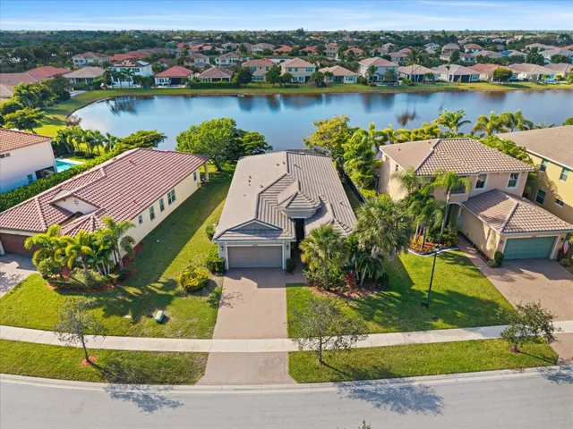 an aerial view of a house with outdoor space and lake view