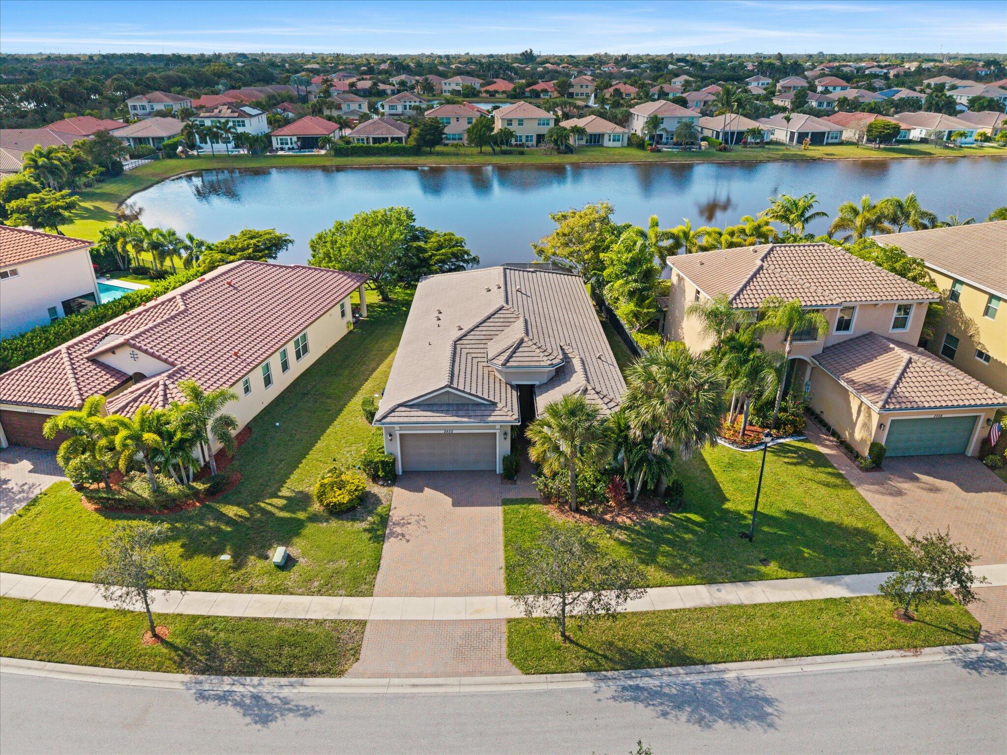2930 Bellarosa Circle Royal Palm Beach, FL 33411 - Photo 1 of 36 an aerial view of a house with outdoor space and lake view