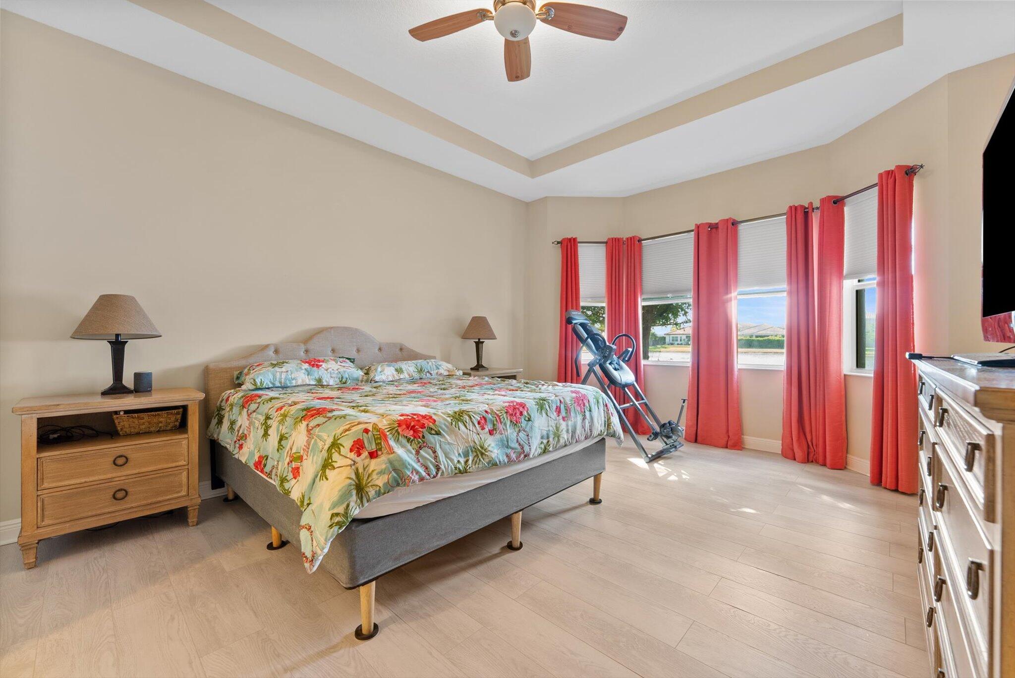 2930 Bellarosa Circle Royal Palm Beach, FL 33411 - Photo 12 of 36 a bedroom with a bed and a chandelier