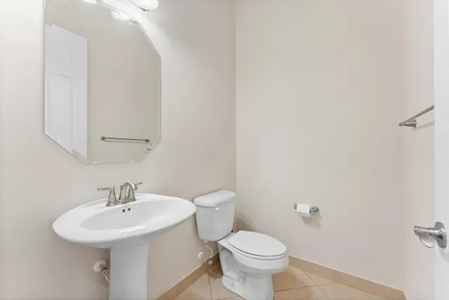 a bathroom with a sink a toilet and mirror